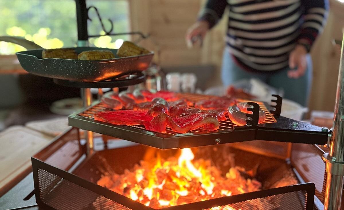 The lit bbq fire pit in the party hut