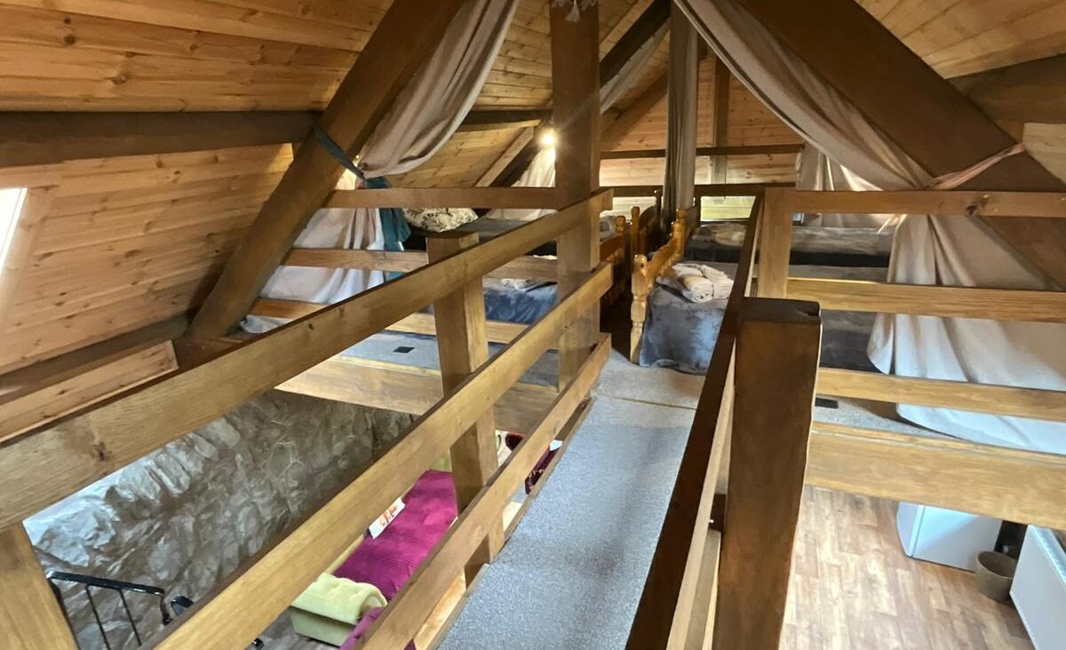 Upstairs in the glamping lodge showing the many beds.