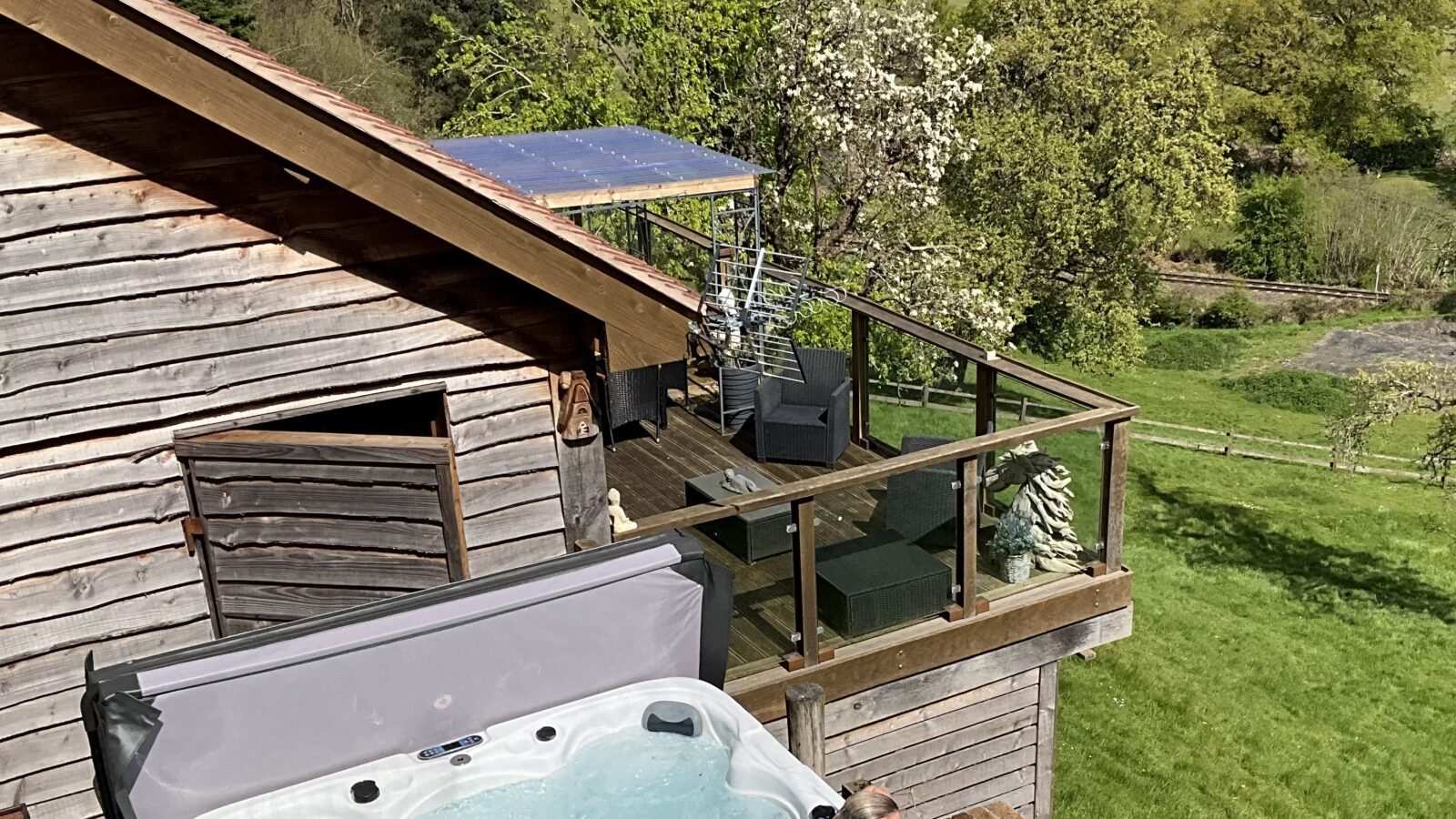 Looking down onto a lady in the swim spa at Bank Farm Glamping lodge