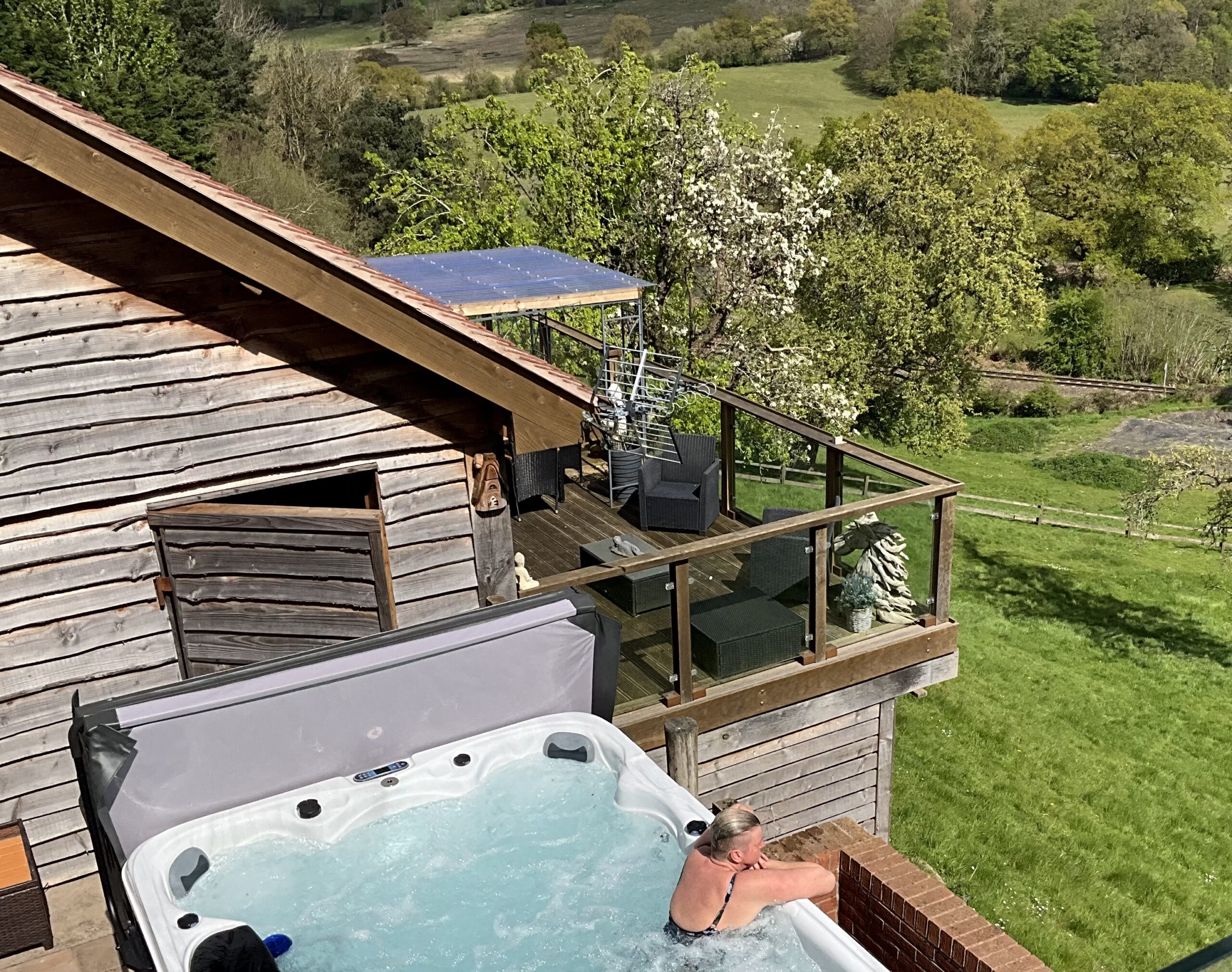 Looking down onto a lady in the swim spa at Bank Farm Glamping lodge
