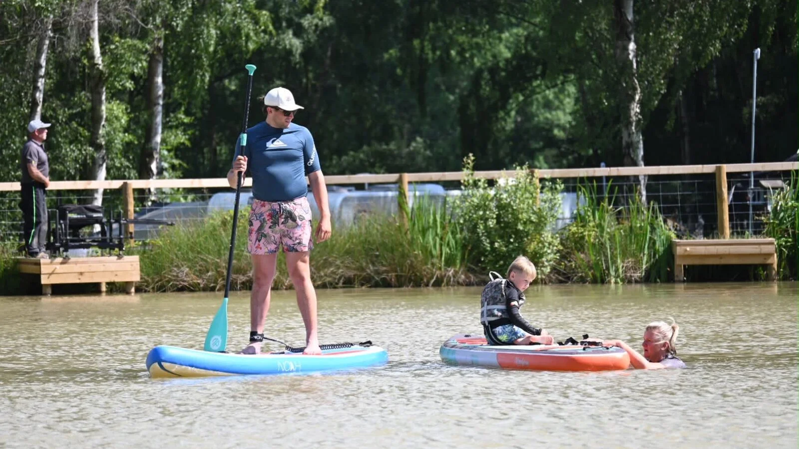 526c2ef6-c1e6-4745-90e5-acdf860f7e21-1600×900 Person by Paddleboarding lake