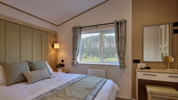 Luxurious master bedroom in the Woodbridge Lodge at Lodge Coppice Holiday Park